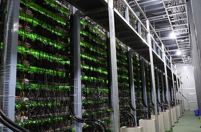 A mining farm with rows of mining rigs operating.
